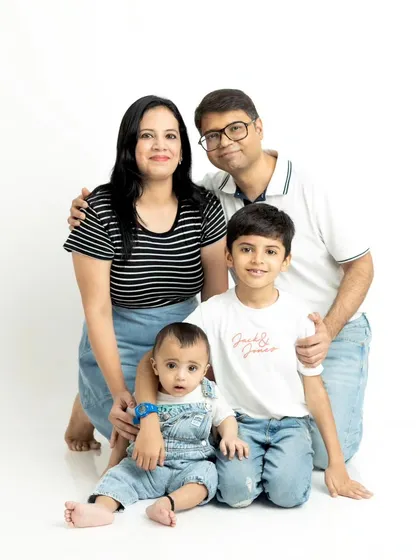 A bright and happy family portrait taken in our studio. We specialize in making everyone comfortable, from babies to older siblings, to capture a relaxed and authentic group photo against a clean white background.