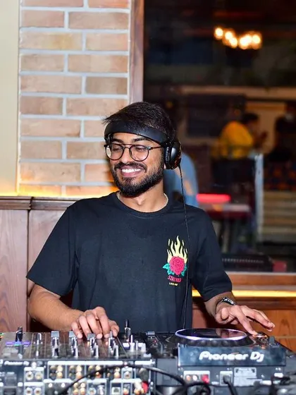 Focused on the mix, making sure every transition is perfect. I see myself as a mastermind at work, crafting the perfect soundtrack for the night.