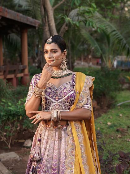 A close-up of the model wearing the multi-color lehenga with traditional jewellery, creating a complete ethnic look.