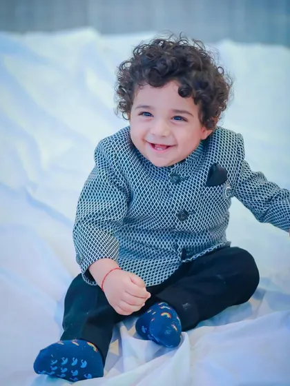 A happy moment captured. This little boy's joyful expression says everything about how comfortable and special he feels in his Vern Kids outfit.