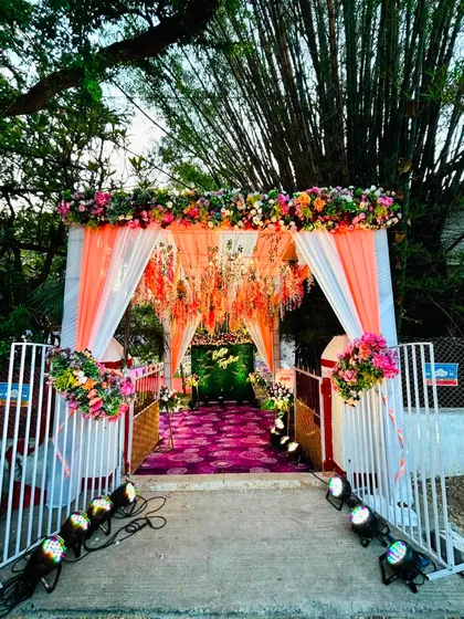 The full view of the colorful engagement entrance, showing the gate and the beautifully decorated path leading to the main event.