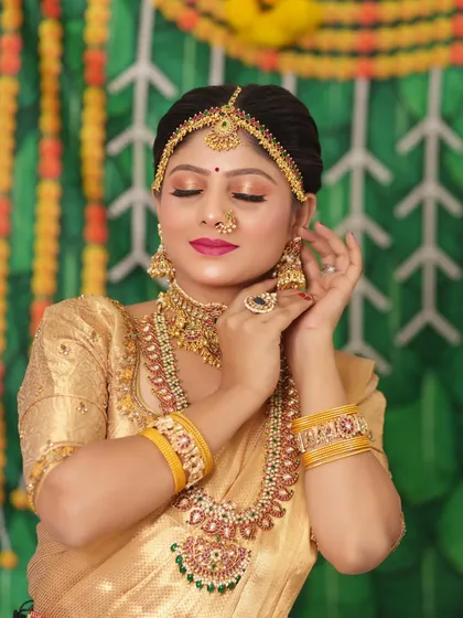 This bride is wearing a beautiful antique set with a golden saree, a classic combination for a Muhurtham.