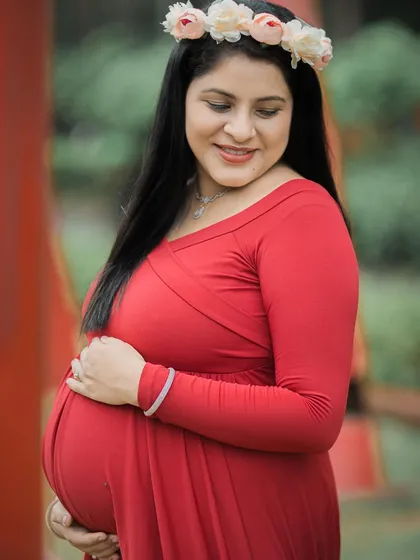 A gentle and happy close-up, focusing on the mom-to-be cradling her baby bump.