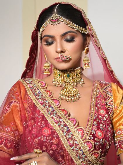 An elegant, eyes-closed pose showing off the detailed eye makeup. The blend of colors and the sharp winged liner create a truly artistic look.