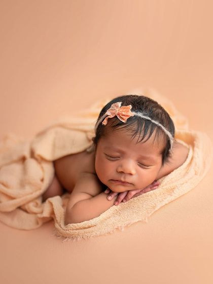 A gentle tummy-time pose, with the baby resting on a soft matching blanket. So simple and so sweet.
