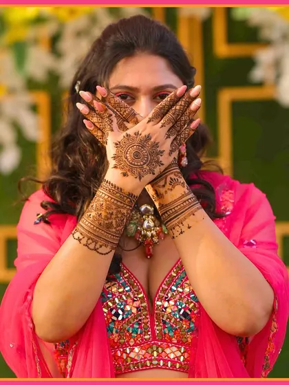 Her hands are a canvas of love. A beautiful shot of the bride showing off her detailed Mehendi design.