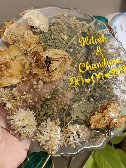 A beautiful geode-style resin plaque preserving a couple's special flowers and memories. The names and date are inscribed in gold, adding a touch of elegance.