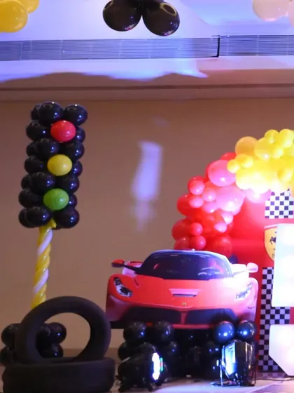 A cool shot of the Ferrari car prop, complete with a balloon traffic light, ready for a photo op at the 5th birthday celebration.