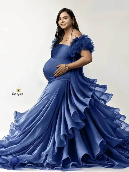A full-length shot of our stunning blue ruffled gown against a clean white background, showcasing the intricate details and vibrant color.