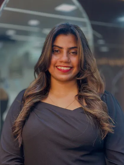 A radiant smile from a happy client. Her soft, subtle highlights and face framing layers give her a warm and approachable look.