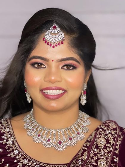 A close-up portrait of Hima. Her makeup is flawless, and her smile shows how confident and beautiful she feels.