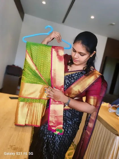 A student from my professional session holding a perfectly hanger-folded saree. I teach various folding techniques in my classes.