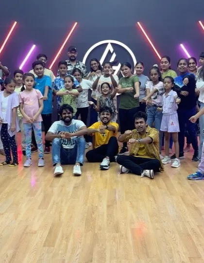 A large and energetic group of kids and adults after a successful workshop.