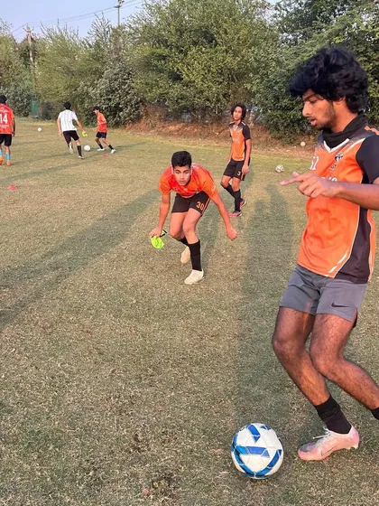 A player dribbling with intensity during a practice game.