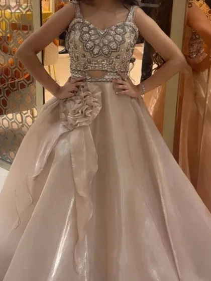 Another angle of the popular beige gown, showing how the embellished top and structured skirt create a beautiful silhouette.