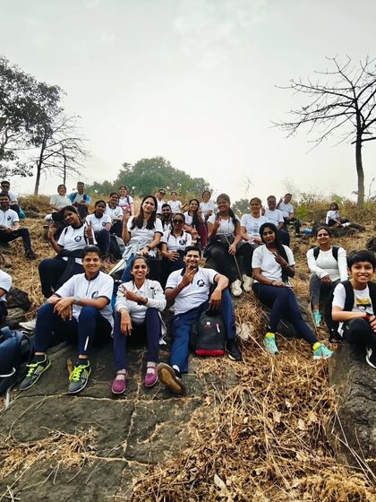 Our students resting on the rocks during a yoga trek. These moments of pause and reflection in nature are just as important as the asanas.