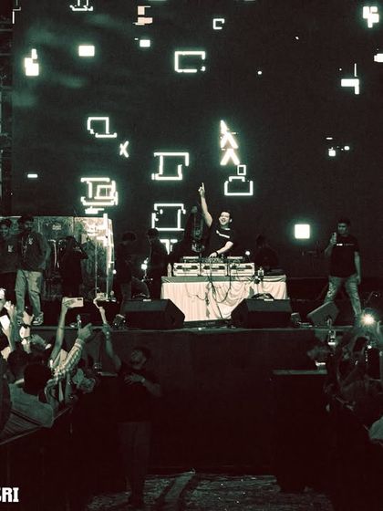 A wide shot of the massive stage setup and the crowd at the AatmTrisha music festival.