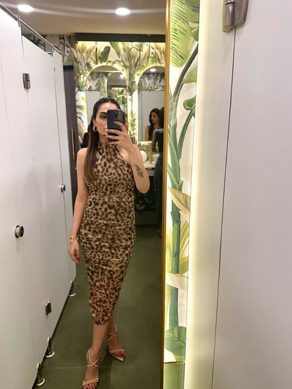 A mirror selfie in a fitted leopard print dress. This is a great option for a night out when you want to make a statement.