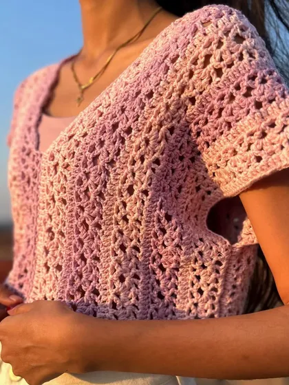 The front view of the crochet lace tee. The delicate, open stitch pattern gives it a beautiful, lightweight feel.