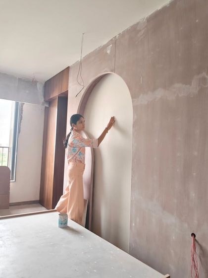 Assessing a primed wall in an arched niche during a site visit. This is where I check the surface for any issues and finalize the placement of the design.