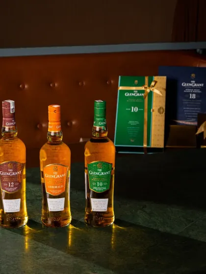 A group shot of three whisky variants, captured on location to create an authentic, high end feel for a festive campaign. The gift boxes in the background position the products as perfect for a special occasion.