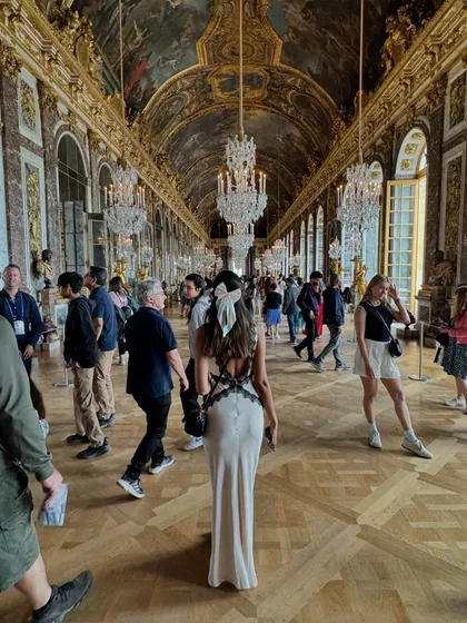 A key part of my philosophy is helping you dress for the life you want. This moment, captured in the iconic Hall of Mirrors at the Palace of Versailles, is all about embodying that main character energy. The elegant backless dress with lace details was perfect for a day of feeling like royalty.