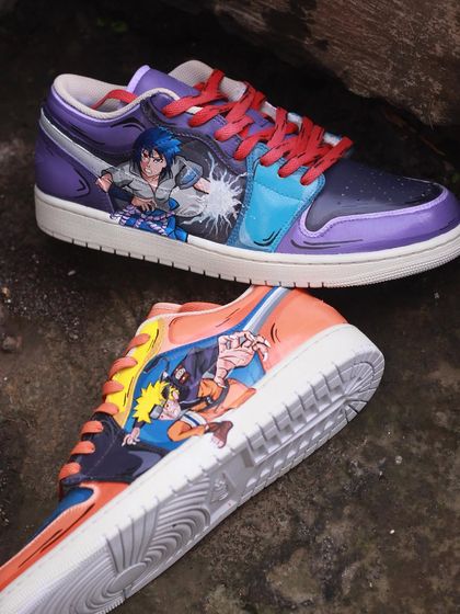 A battle of rivals on your feet. This pair of Air Jordan 1s features Naruto on one shoe and Sasuke on the other, captured in the middle of a fight. The artwork wraps around the shoe, making it a dynamic piece from every angle.