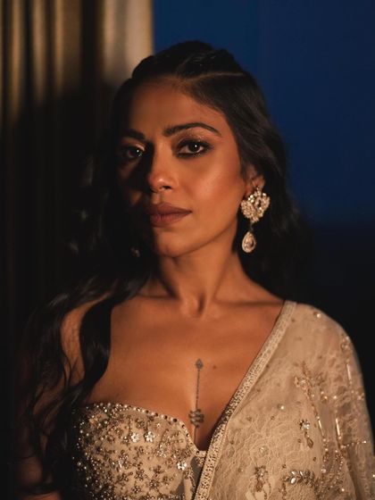 A close-up portrait of Anasuya Sengupta, capturing her strength and poise. The dramatic lighting and her direct gaze make this a powerful and intimate shot.