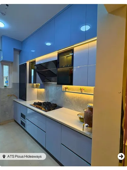 A kitchen should be as beautiful as it is functional. This modern modular kitchen features a cool blue palette, sleek handleless cabinets, and smart under-cabinet lighting, creating an efficient and stylish space for cooking and family time.