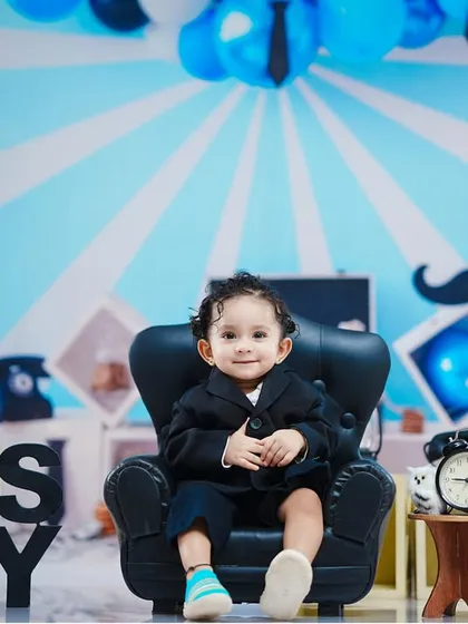 A full view of the Boss Baby setup, with a "one" sign to mark his first birthday.