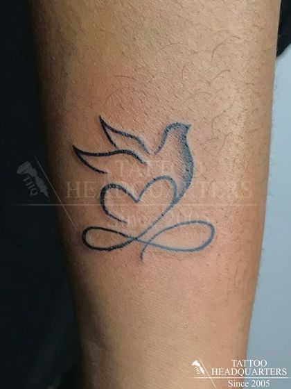 A minimalist design of a dove that incorporates a heart and an infinity symbol, representing peace, love, and eternity.