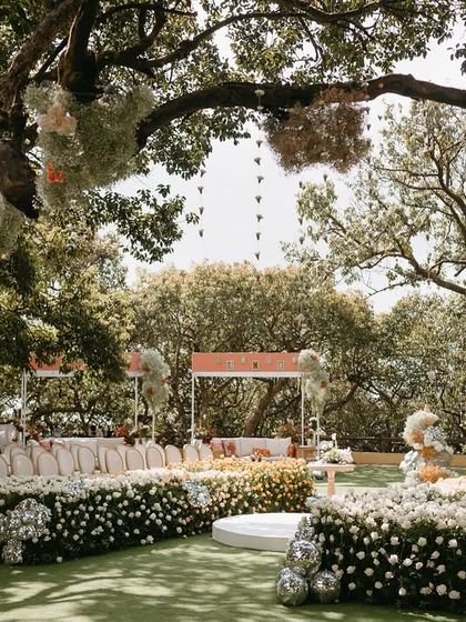 An expansive view of Aashna and Armaan's garden ceremony. The layout was designed to be inclusive, with a circular floral aisle and comfortable lounge seating, ensuring every guest had a perfect view of the vows.
