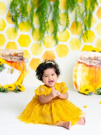 What's sweeter than honey? A baby's smile! This adorable "bee-day" setup with a honeycomb background and honey pots is a creative and cute theme for a first birthday.