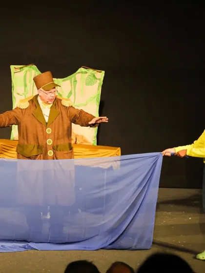 Another audience participation moment from 'Penguin in my Pocket', where a young girl helps create the 'sea' with a blue cloth.