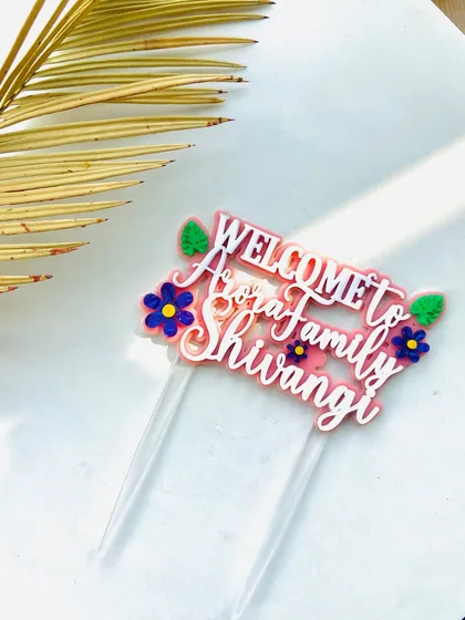 Another angle of the "Welcome to Arora Family" topper, showing its clean lines and bright colors.