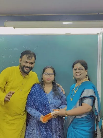 Prof. Parab and Leena Miss with a student during the Diwali gift exchange. We believe in acknowledging and celebrating every member of our Divesh Classes community.
