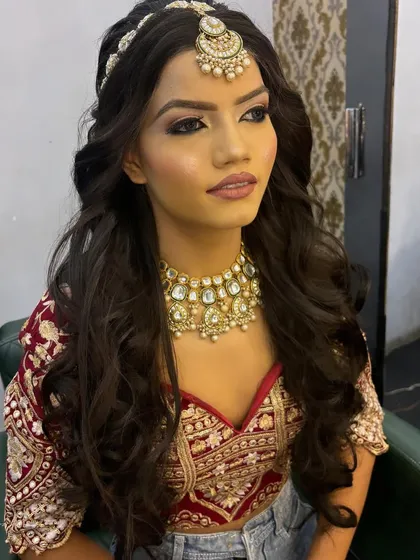 A model showcasing a soft bridal look with open, wavy hair. This is a great example of the looks we create for our students' portfolio shoots.
