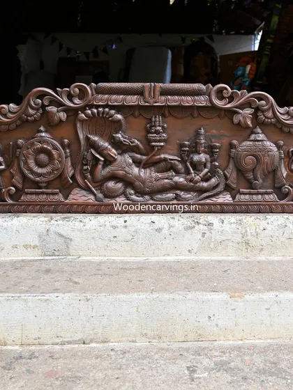 This 48-inch panel depicts Lord Narayanar (Vishnu) reclining on the serpent Adisesha. It is a classic representation of divine rest and cosmic order, carved with serene detail.