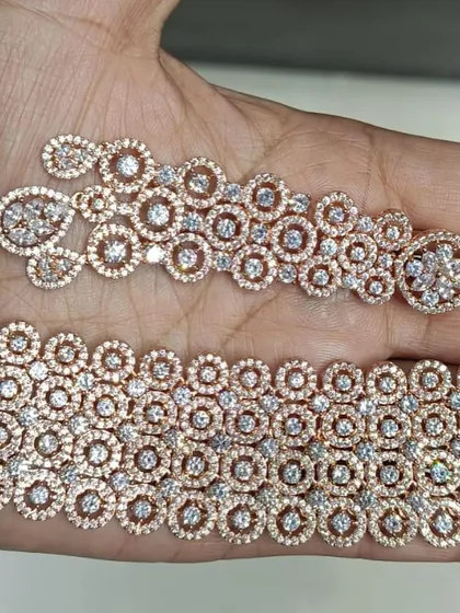 A beautiful rose-gold polished American Diamond choker and earring set. The design features interconnected circles for a modern, geometric look.