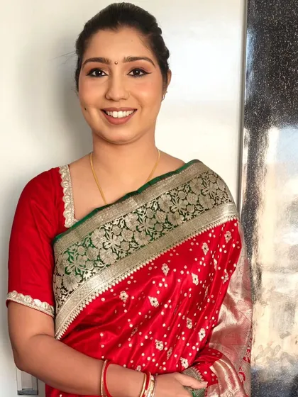 A classic party look with a neat bun hairstyle. This is a great option for pairing with a traditional saree, especially for a formal event.