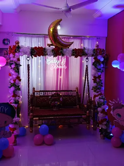 The same baby shower swing setup from a different angle, showing how it fits into a living room.