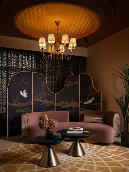 In this zone, we brought together soft mauve, rich mustard, and deep midnight blue to create a feeling of quiet opulence. The custom-designed curved sofa and the intricately embroidered fabric partition are bespoke pieces that define the character of this intimate lounge area within the retail space.