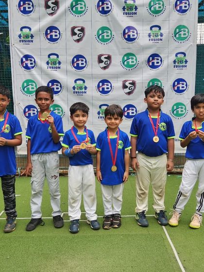 Young champions from our HB Jr. Cup, proudly displaying their medals. We believe in celebrating participation and effort at every level of the game.