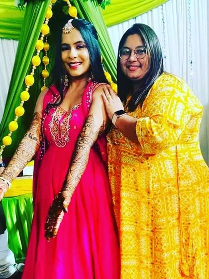 A lovely photo of a bride with her family member at the mehndi ceremony. It's a celebration for everyone.