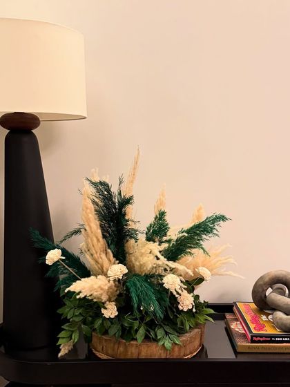 A small, tasteful arrangement of pampas grass and other dried elements on a side table. These little touches in every corner help to create a cohesive and fully styled event space.