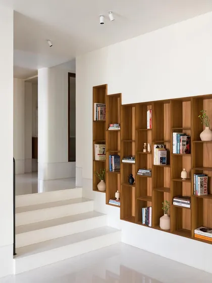 This recessed bookcase climbs along the staggered floors of the home, turning a transitional space into a central feature. I design storage that is not just for holding things, but that also adds architectural interest and tells a story.