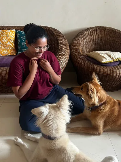 Harmony in a multi-pet household is a beautiful thing. Here, two dogs are calmly interacting with me, showing that training can create a peaceful environment. It's about building trust and understanding, not just obedience.