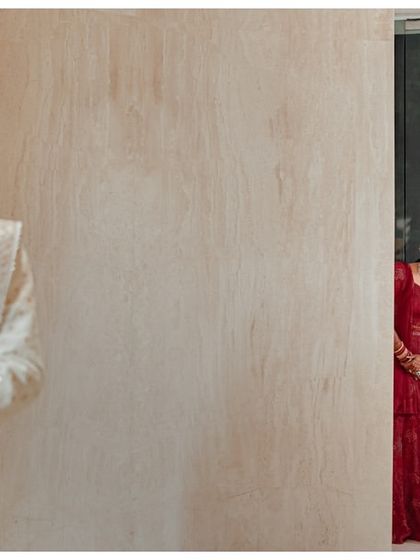 The moment of anticipation before the first look. Katyayni peeks from behind a door as Kunal waits, creating a playful and exciting narrative in a single frame.