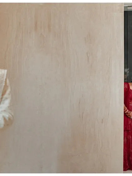 The moment of anticipation before the first look. Katyayni peeks from behind a door as Kunal waits, creating a playful and exciting narrative in a single frame.