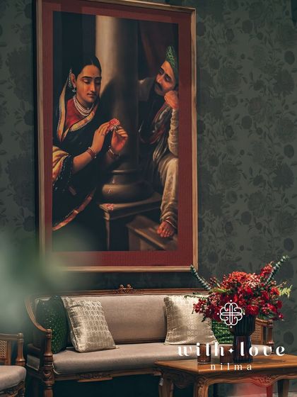 A view of the lounge seating, with a Raja Ravi Varma painting creating a stunning focal point. The decor is a tribute to the couple's love for art and history.